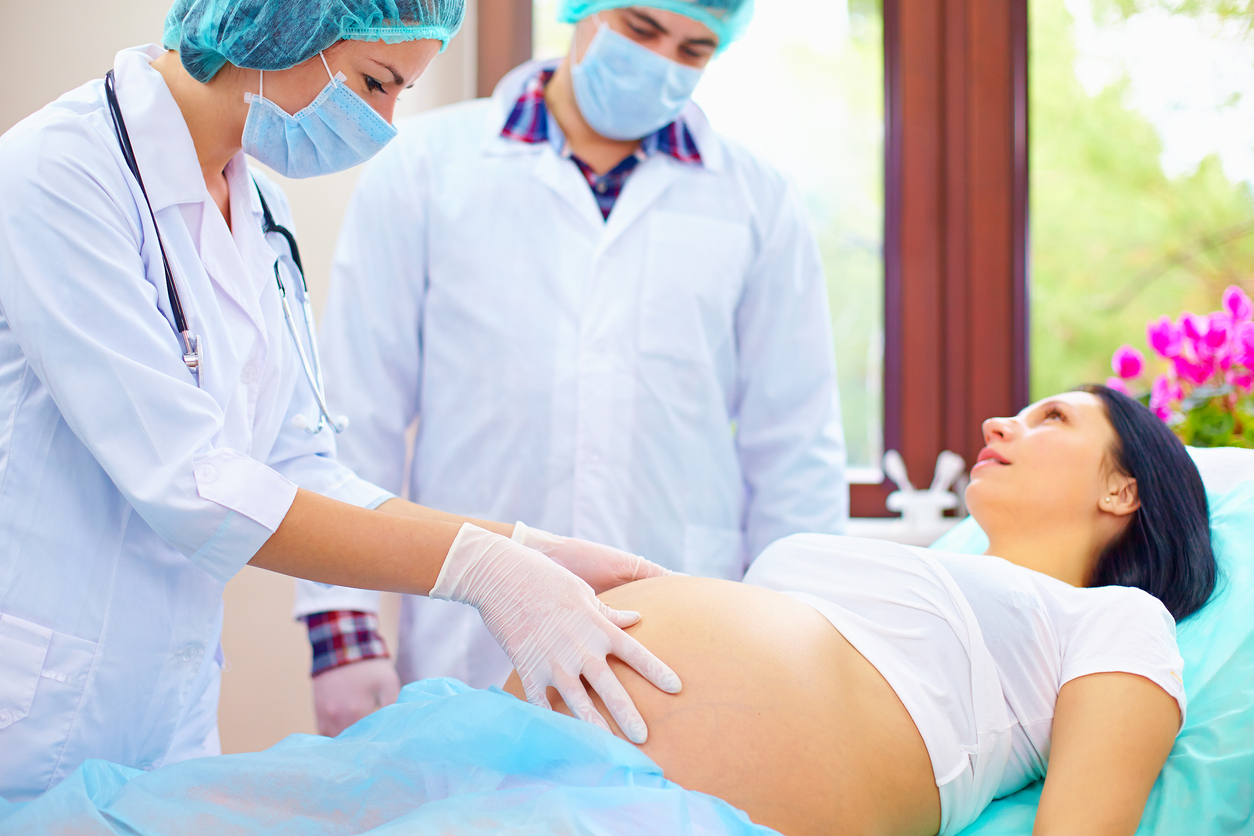 doctor-palpates-the-abdomen-of-pregnant-woman-during-childbirth-493302412_1257x838.jpeg
